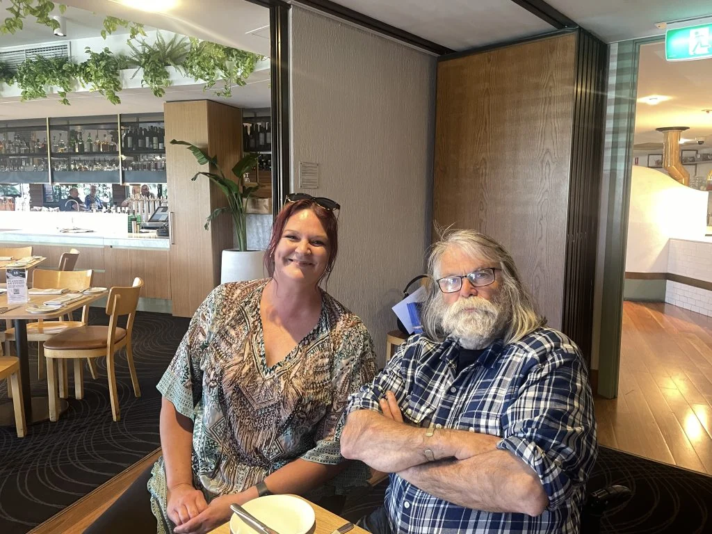 Two people sitting at a table in a restaurant.