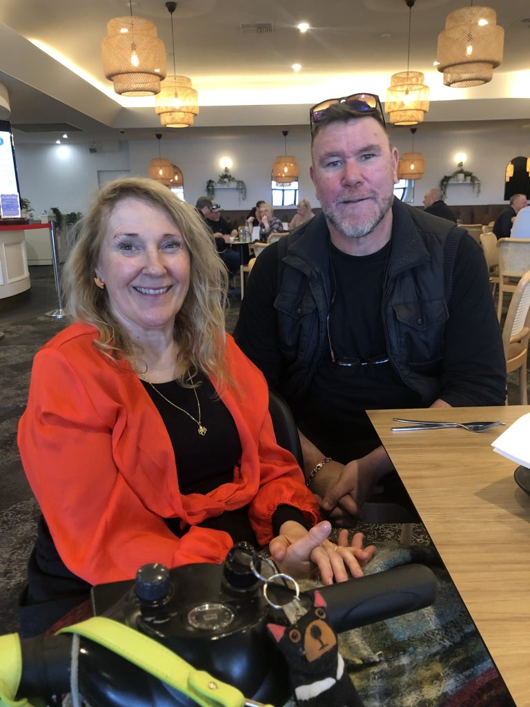 A man and woman sitting at a table.