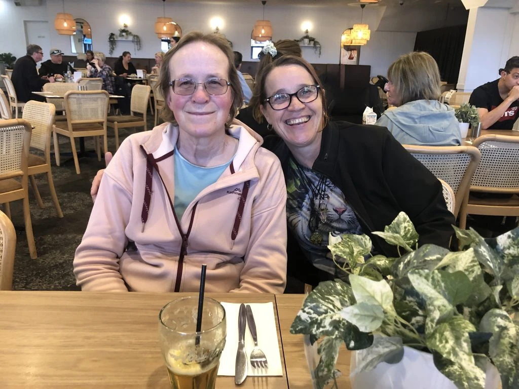 Two women sitting at a table in a restaurant.