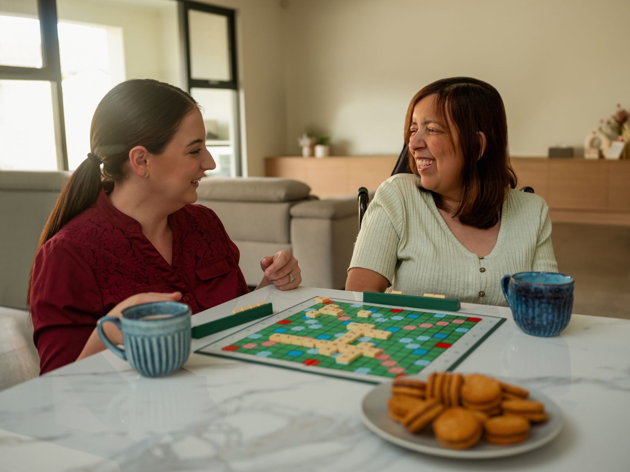 Two women playing a game of scrabble.