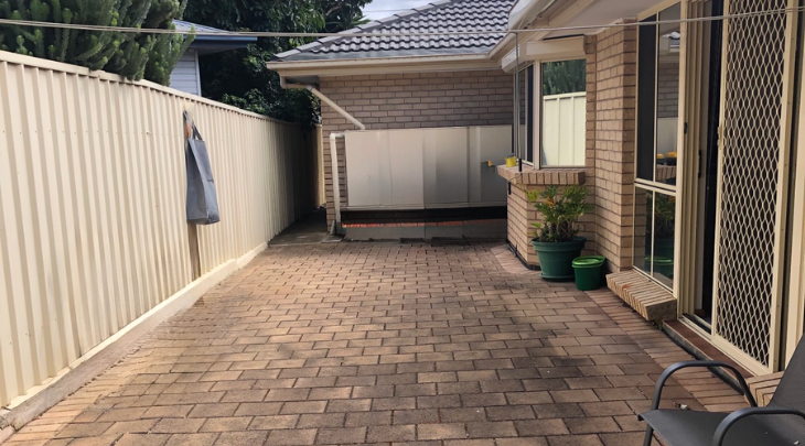 A small backyard with a table and chairs.