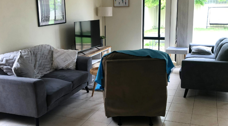 A living room with a couch and tv.