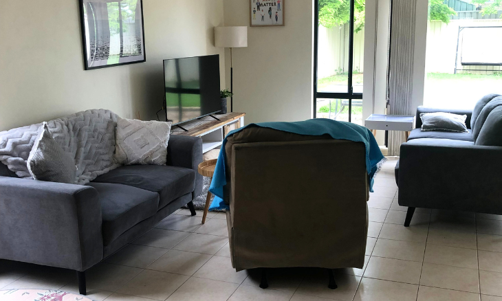 A living room with a couch and tv.