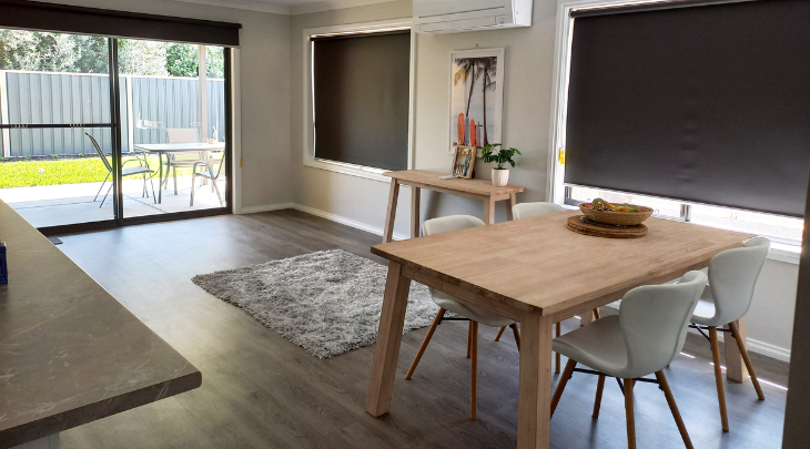 A living room with a dining table and chairs.