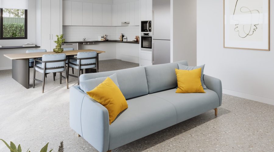 A modern, open-concept kitchen and living area with a light blue sofa featuring yellow pillows, a dining table with chairs, and minimalistic decor.