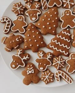 Gingerbread cookies on a plate with christmas decorations.