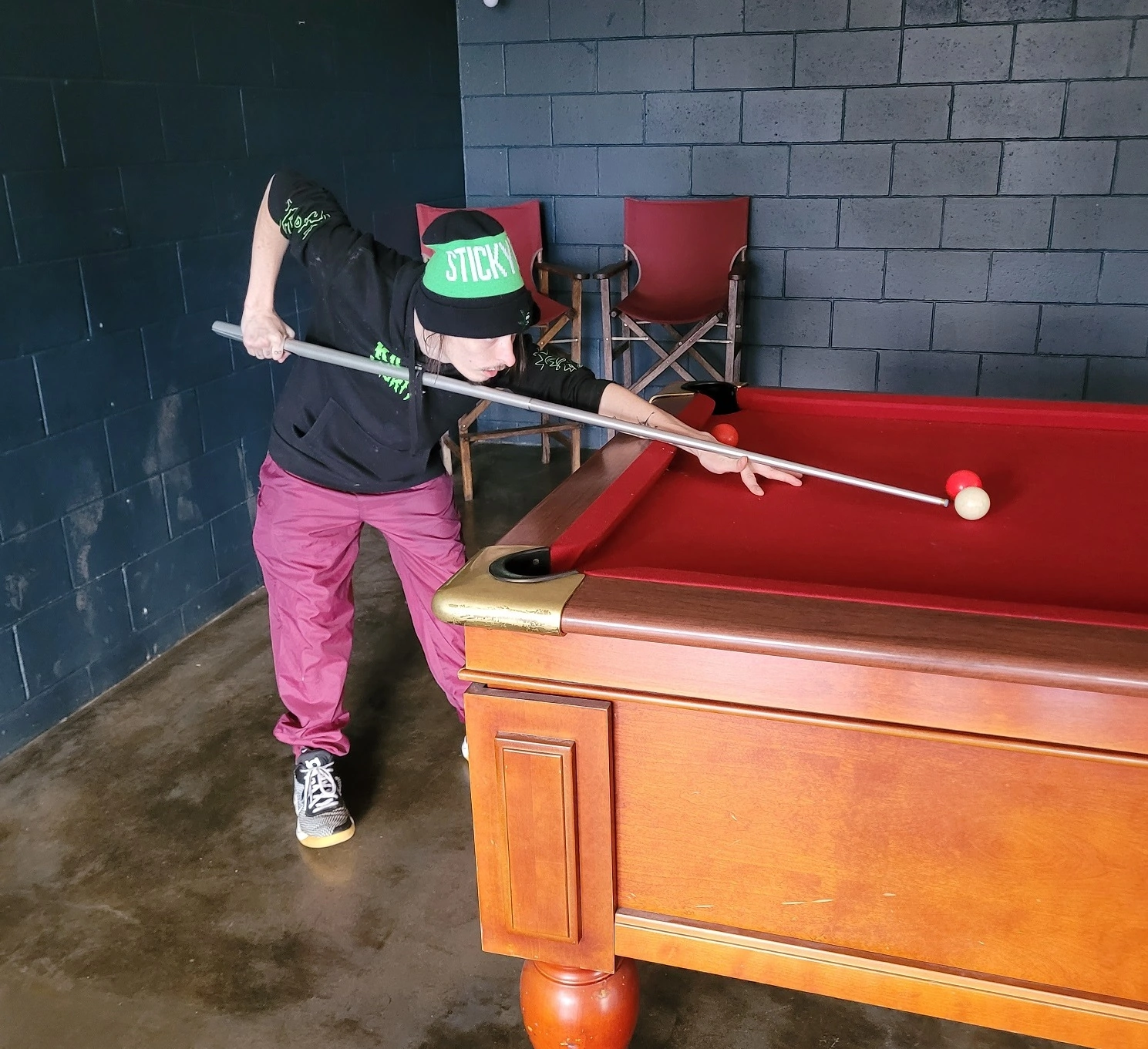 A young man playing pool