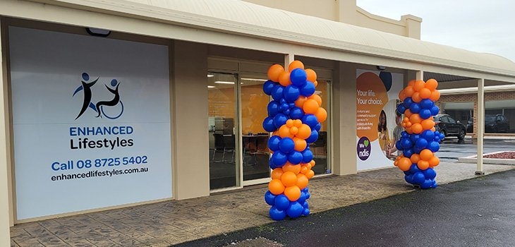 The front elevation of the Mt Gambier office with the front two veranda posts covered with orange and blue balloons to celebrate its opening
