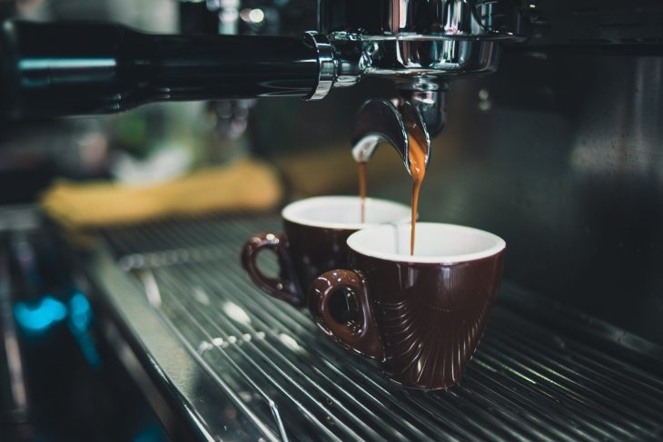 Image of coffee being extracted from a professional espresso machine