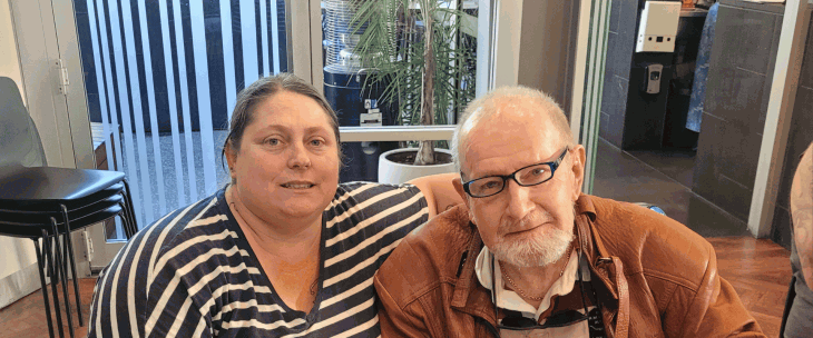 Male NDIS participant being supported by his female LA at a coffee shop