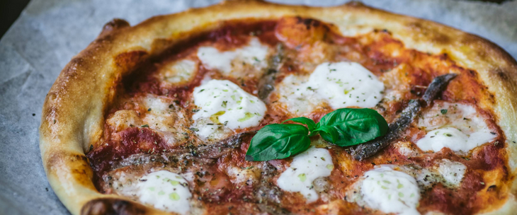 A flavorful and fresh pizza perfect for a quick lunch that combines mozzarella and basil toppings.