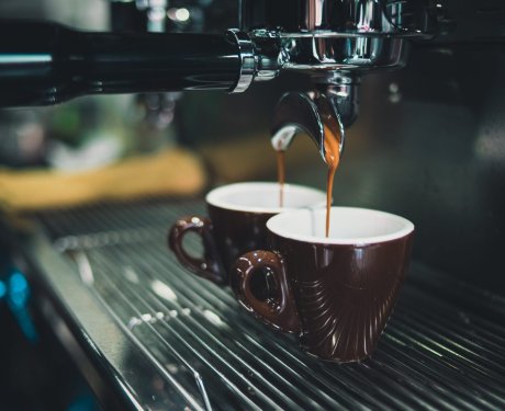 Image of coffee being extracted from a professional espresso machine