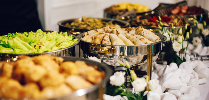 A buffet with a variety of food on it.