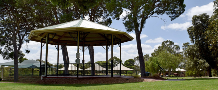A gazebo sits in the middle of a park.